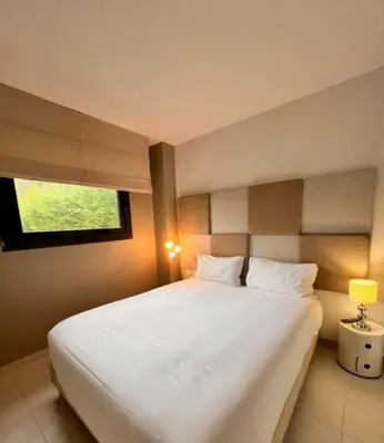 a bedroom with a large white bed with a window at Arthur Properties - Montfleury in Cannes