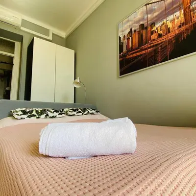 a bedroom with a bed with a white towel on it at RIVIERA STUDIO CANNES CENTER in Cannes
