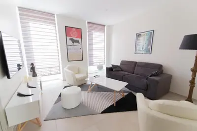 a living room with a couch and a table at Alceste Apartment - Cannes Banane in Cannes