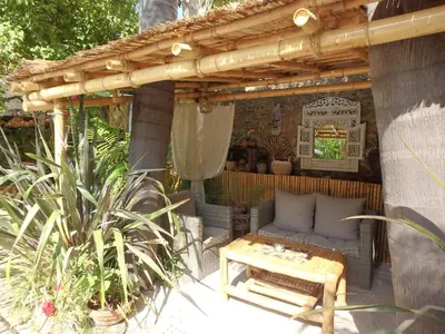 a path through a garden with pink flowers and plants at Residence Veles Plage in Cannes