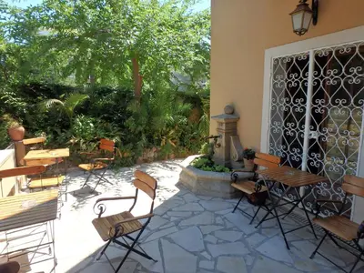 a patio with chairs and a table and a table at Residence Veles Plage in Cannes