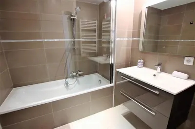 a bathroom with a shower and a tub and a sink at VENDÔME APARTMENT in Cannes