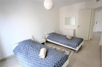 two beds in a small room with two at VENDÔME APARTMENT in Cannes