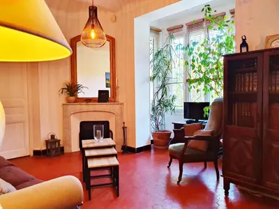 a living room with a couch and a fireplace at Bed & Breakfast Chambres d'hôtes COTTAGE BELLEVUE in Cannes