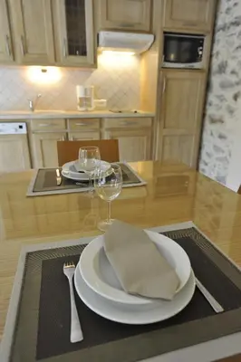 a kitchen and dining room with a wooden table and chairs at La Bastide du Soleil in Cannes