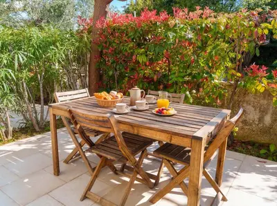 a living room with a staircase and a table at La Bastide du Soleil in Cannes