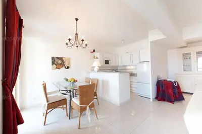 a kitchen and dining room with a table and chairs at Blanc cel in Cannes