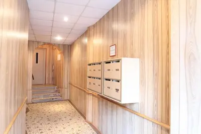 a hallway with wood paneled walls and a hallway with a staircase at Blanc cel in Cannes