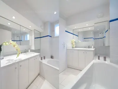 a white bathroom with two sinks and a tub at Blanc cel in Cannes