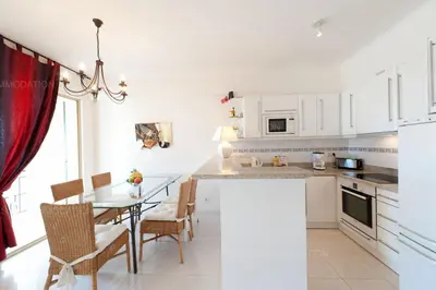 a kitchen and dining room with a table and chairs at Blanc cel in Cannes