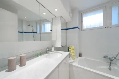 a bathroom with a sink and a large mirror at Blanc cel in Cannes