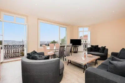 a living room with couches and a table at Carrousel 4 in Cannes