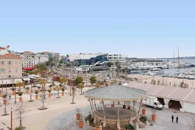 a city with a gazebo and a harbor with boats at Carrousel 4 in Cannes