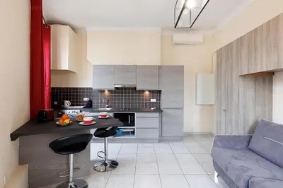 a kitchen and living room with a couch and a table at Carrousel stud in Cannes