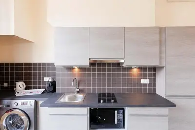 a kitchen with a sink and a washing machine at Carrousel stud in Cannes