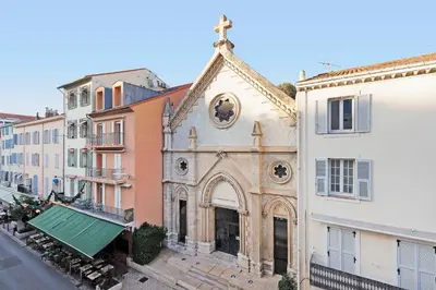 an old church in the middle of some buildings at Cruise in Cannes