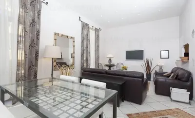 a living room with a couch and a glass table at Feliz in Cannes