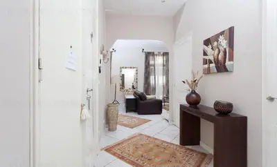 a hallway with a living room with a couch at Feliz in Cannes