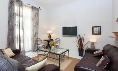 a living room with a couch and a table at Feliz in Cannes