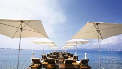 a long row of chairs and umbrellas on the water at Victoria in Cannes