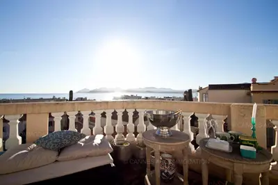 a balcony with a table and a trophy on it at Victoria in Cannes