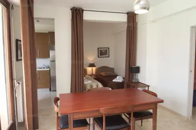 a dining room with a table and a bedroom at Velapop in Cannes