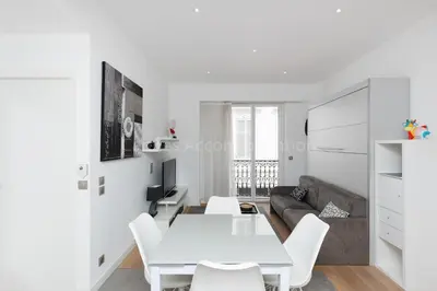a white living room with a white table and white chairs at Sparkle in Cannes