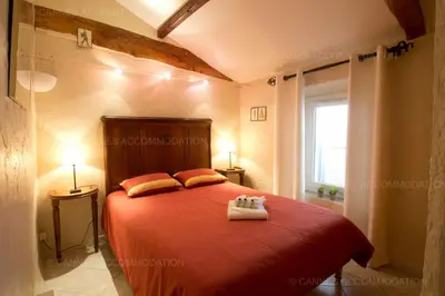 a bedroom with a red bed with two pillows at Maillot in Cannes