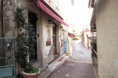 an empty alley with a plant in a pot on a building at Maillot in Cannes