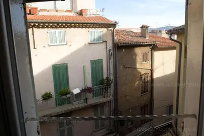 a view from a window of an alley with buildings at Maillot in Cannes