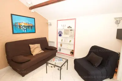 a living room with a couch and a chair at Maillot in Cannes