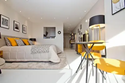 a bedroom with a bed and a table and chairs at Khayat in Cannes