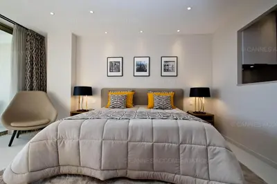 a bedroom with a large bed and two lamps at Khayat in Cannes