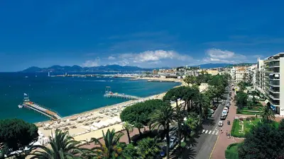 a black and white photo of a street with buildings at Gray 2A2 in Cannes