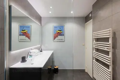 a bathroom with a white sink and a shower at Gray 2A2 in Cannes