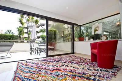 a living room with a red chair and a rug at Gray 2A2 in Cannes