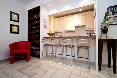 a kitchen with a bar and a red chair at Gray 2A2 in Cannes