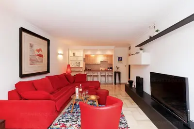 a living room with a red couch and red chairs at Gray 2A2 in Cannes