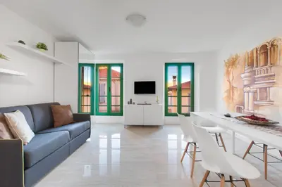 a living room with a blue couch and a table at Cannes Old Town Suites in Cannes