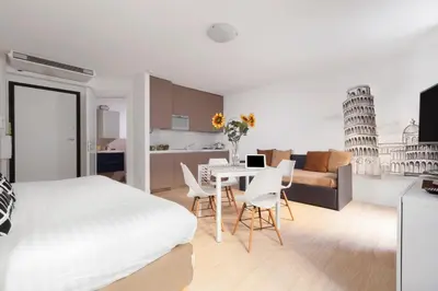 a bedroom with a bed and a table and chairs at Cannes Old Town Suites in Cannes