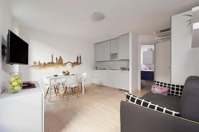 a kitchen and living room with a table and chairs at Cannes Old Town Suites in Cannes