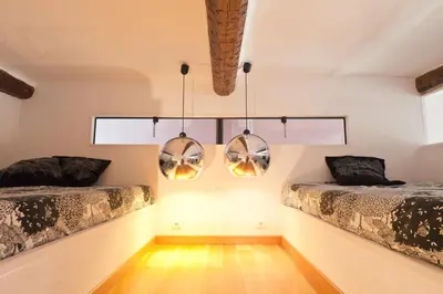 two beds in a room with two windows at Festival Apartment in Cannes