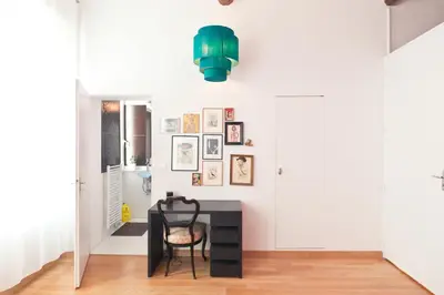 a dining room with a table and a green chandelier at Festival Apartment in Cannes