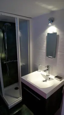 a bathroom with a white sink and a shower at Festival Apartment in Cannes