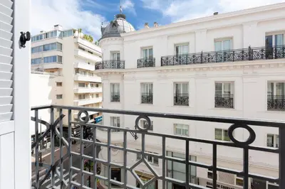 a view of a white building from a balcony at Cosy apartment 27 m2 in rue d'Antibes and Croisette in Cannes