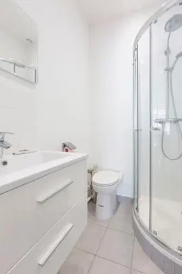 a white bathroom with a shower and a toilet at Cosy apartment 27 m2 in rue d'Antibes and Croisette in Cannes