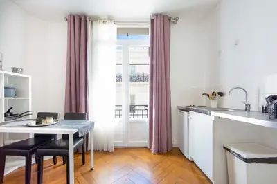 a kitchen with a table and a dining room at Cosy apartment 27 m2 in rue d'Antibes and Croisette in Cannes