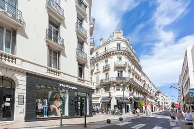 a street in a city with tall white buildings at Cosy apartment 27 m2 in rue d'Antibes and Croisette in Cannes