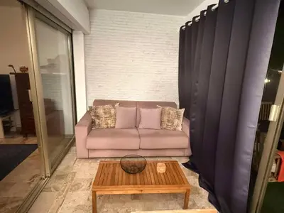 a living room with a couch and a coffee table at 13 Rue Edith Cavell in Cannes