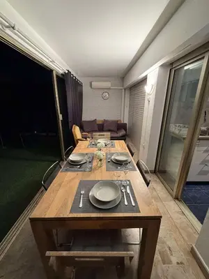 a table in a room with a couch at 13 Rue Edith Cavell in Cannes
